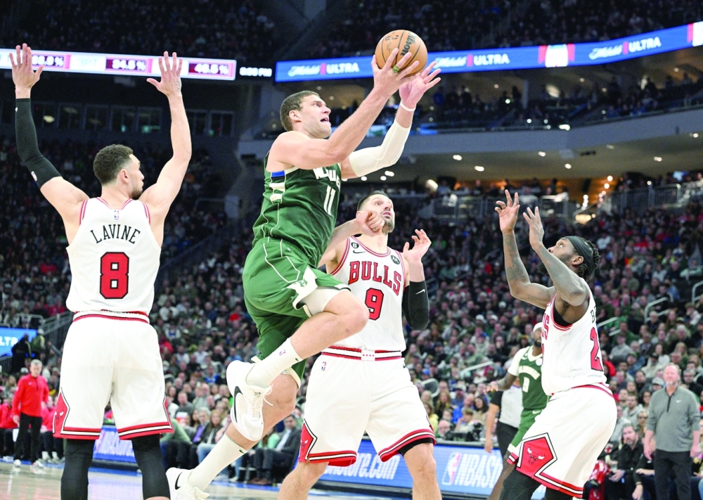 Milwaukee, Wisconsin, USA; Milwaukee Bucks center Brook Lopez (11) drives to the basket against the Chicago Bulls center Nikola Vucevic (9) in the second half at Fiserv Forum. Mandatory Credit: Michael McLoone-USA TODAY Sports