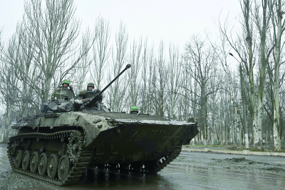 Ukrainian servicemen ride on a BMP infantry fighting vehicle on a road near Bakhmut, Donetsk region. — AFP 