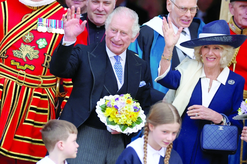 Britain's King Charles and Camilla, Queen Consort, wave as they attend the Maundy Thursday Service at York Minster, in York, Britain, on Thursday. — Reuters