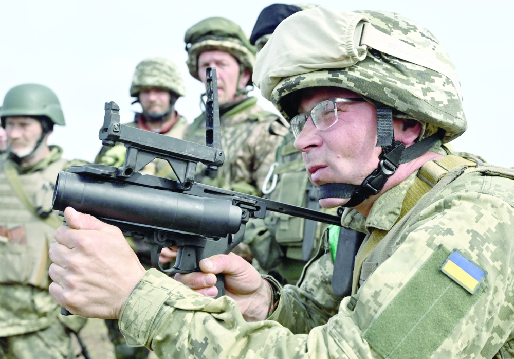 A Ukrainian serviceman aims to fire a grenade launcher as he attends a training exercise in the Donetsk region amid the Russian invasion of Ukraine. - AFP


