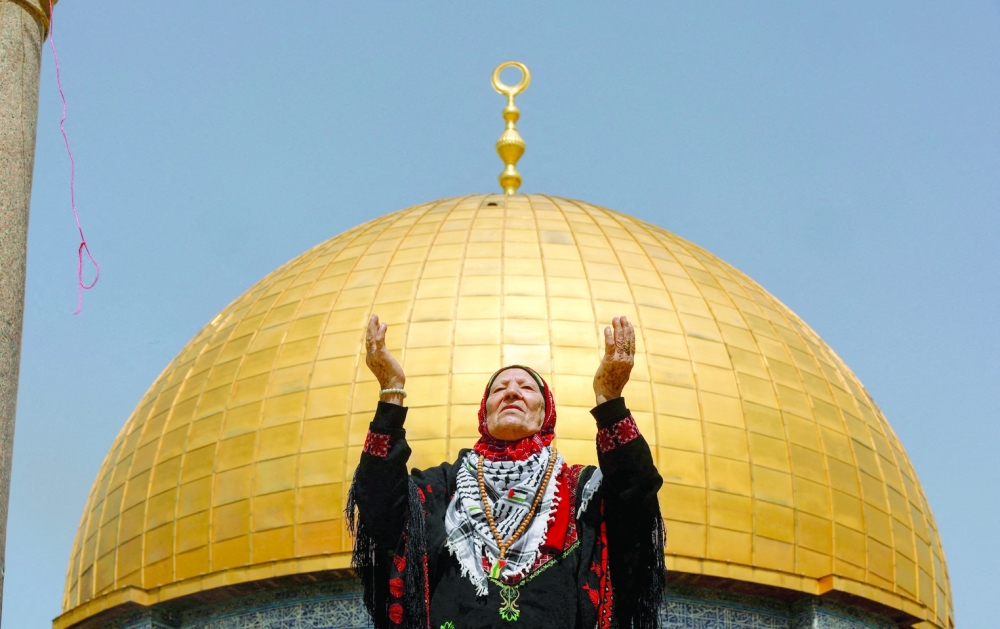 A woman prays at Al Aqsa compound during the third Friday prayer of Ramadhan in Jerusalem on Friday. — Reuters
