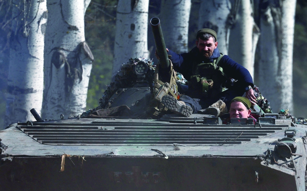 An armoured military vehicle speeds through Chasiv Yar during heavy fighting at the frontline of Bakhmut and Chasiv Yar, Ukraine, on Monday. - Reuters