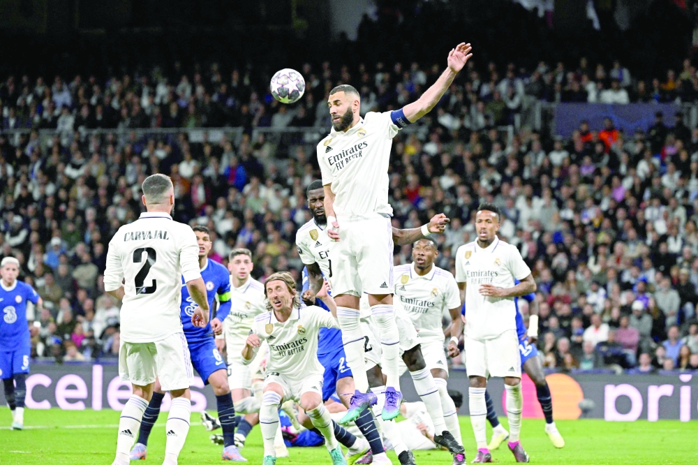 Real Madrid's French forward Karim Benzema heads the ball during the UEFA Champions League quarter final first leg football match between Real Madrid CF and Chelsea FC at the Santiago Bernabeu stadium in Madrid on April 12, 2023. (Photo by JAVIER SORIANO / AFP)

