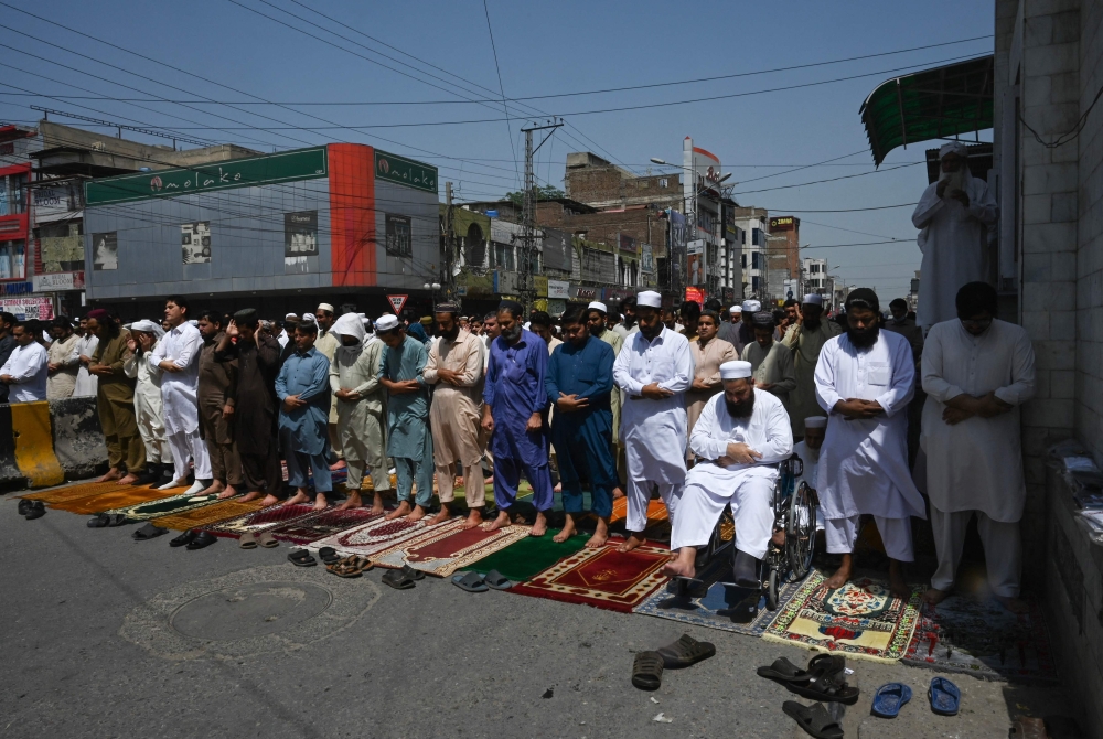 Muslim devotees offer the Last Friday prayers of the holy month of Ramadan at a mosque in Peshawar on April 14, 2023. (Photo by Abdul MAJEED / AFP)

