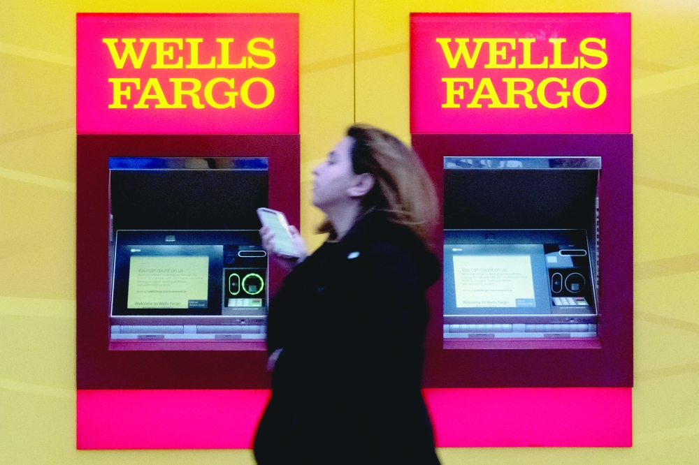 A woman walks past Wells Fargo bank in New York City. - Reuters

