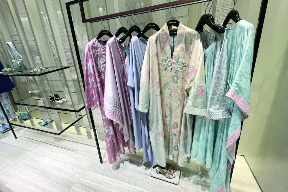 Soft-coloured robes, part of the Ramadhan collection, are inside the Giorgio Armani shop in the Mall of the Emirates in Dubai. - AFP