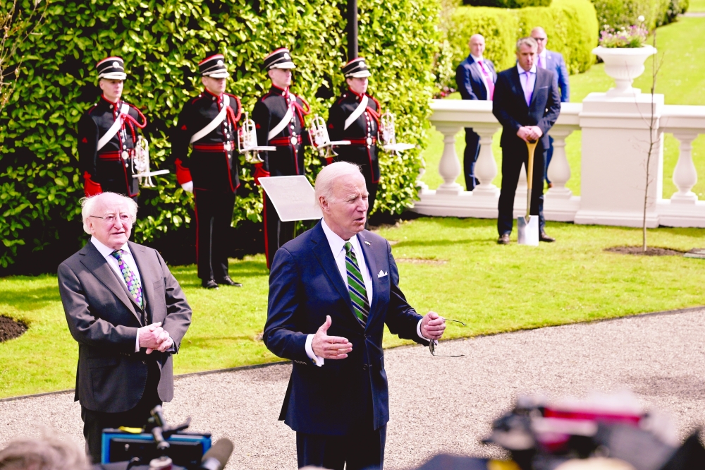 President Joe Biden speaks to reporters as he meets with President Michael Higgins of Ireland at Aras an Uachtarain, the presidential residence, in Dublin.
