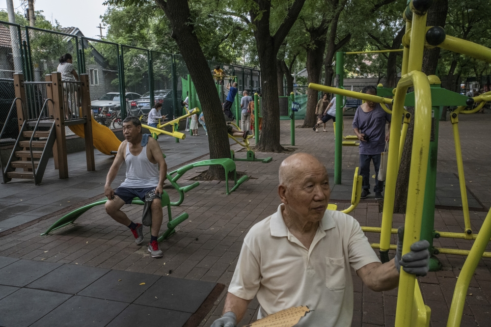 Senior citizens working out in a park in Beijing, on Aug. 12, 2022. (Gilles Sabrié/The New York Times)