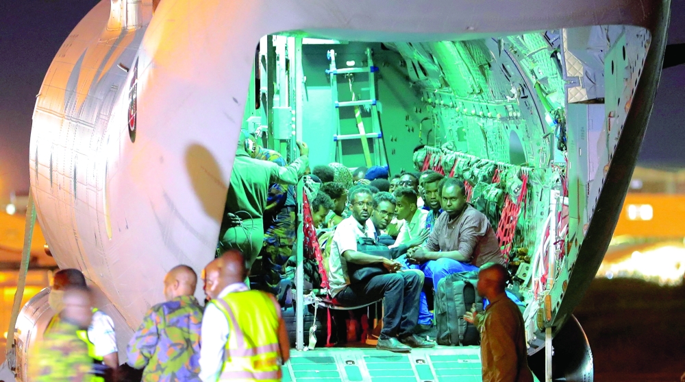 Evacuees from Sudan sit inside a military plane as they wait to be processed by members of the Kenya Defence Forces (KDF). — Reuters 