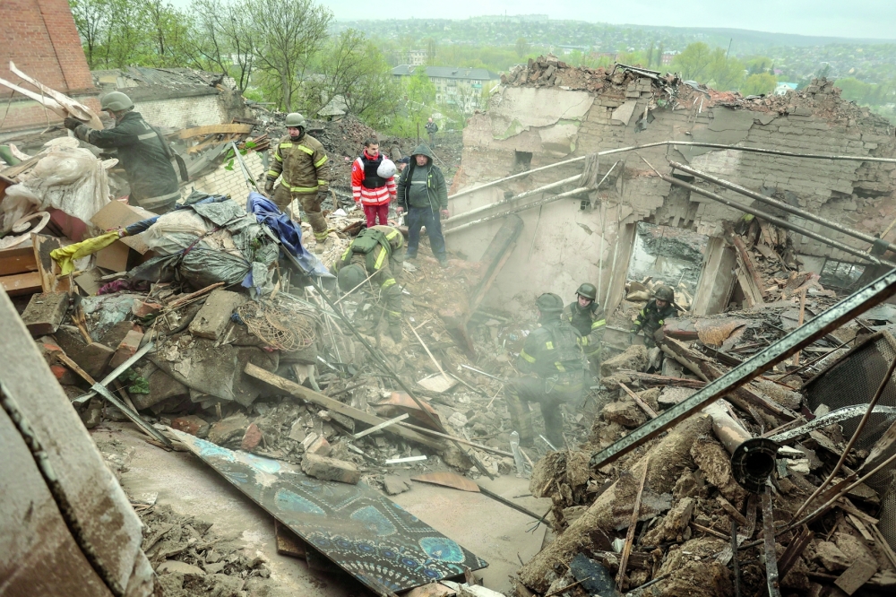 Rescuers and volunteers work at the site of a building of local museum heavily damaged in the town of Kupiansk, Ukraine. — Reuters 