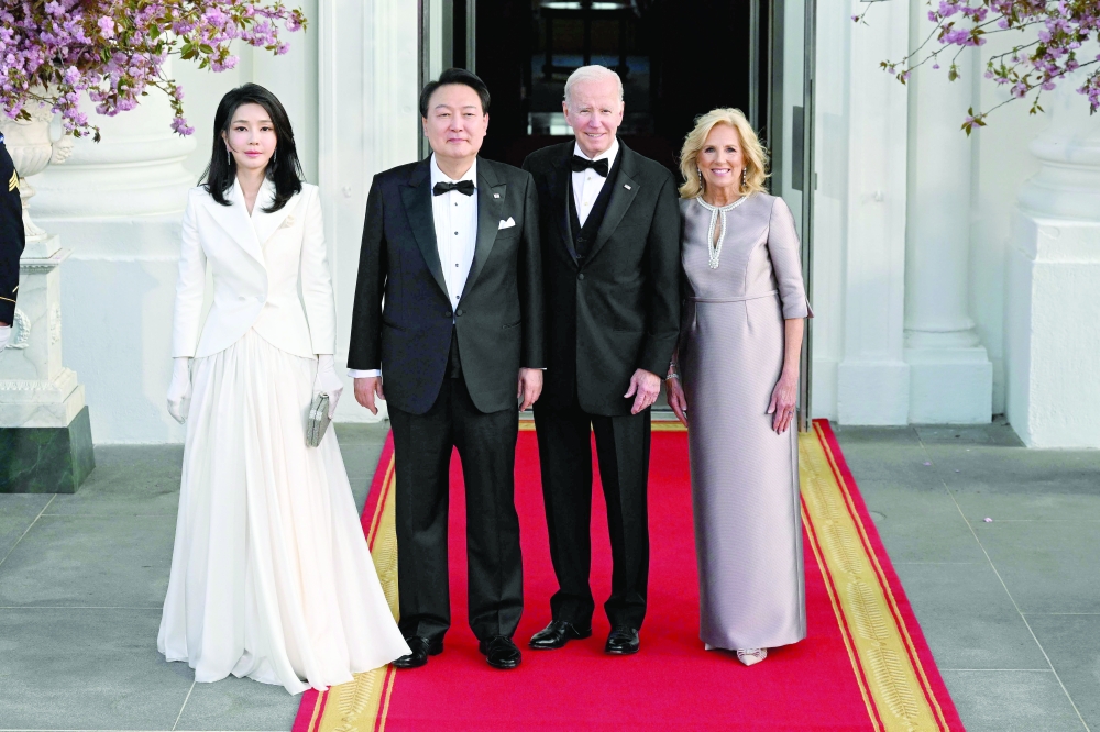 South Korean President Yoon Suk Yeol and his wife Kim Keon Hee (L) pose with US President Joe Biden and US First Lady Jill Biden ahead of a State Dinner at the White House in Washington, DC. - AFP
