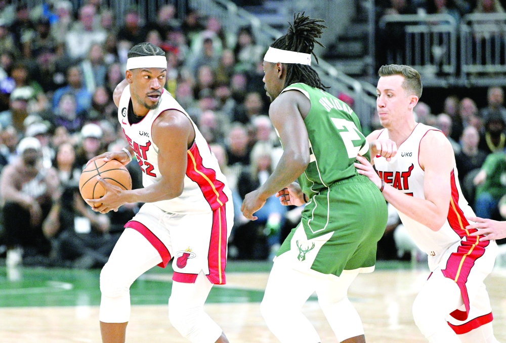 Miami Heat forward Jimmy Butler (22) drives against Milwaukee Bucks guard Jrue Holiday (21) during game five of the 2023 NBA play-offs at Fiserv Forum. Mandatory Credit: Michael McLoone-USA TODAY Sports