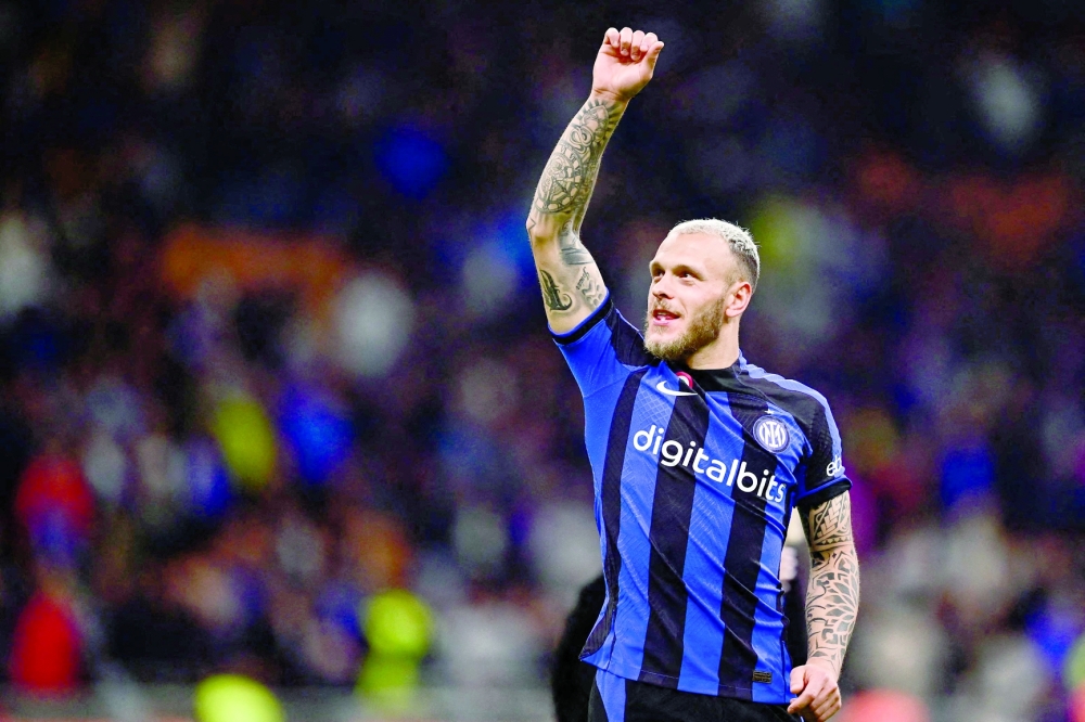 Inter Milan's Italian defender Federico Dimarco celebrates after winning the Italian Cup semifinal second leg football match between Inter Milan and Juventus at the Giuseppe-Meazza (San Siro) stadium in Milan, on April 26, 2023. (Photo by Marco BERTORELLO / AFP)