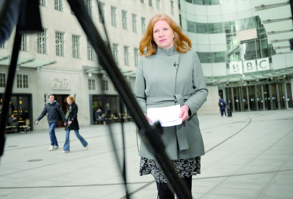 A TV news presenter prepares speak to camera at front entrance of the headquarters of BBC in London on the day the BBC chairperson Richard Sharp resigned. - AFP