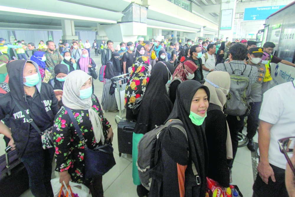The first group of Indonesians evacuated from strife-torn Sudan arrive at Soekarno-Hatta International airport in Jakarta on April 28, 2023, after a chartered flight from Saudi Arabia. - AFP