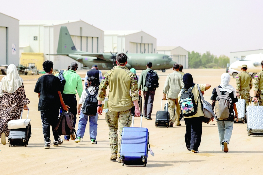 British nationals walk to board an RAF aircraft, during the evacuation to Cyprus, at Wadi Seidna Air Base in Sudan April 27, 2023 - REUTERS 