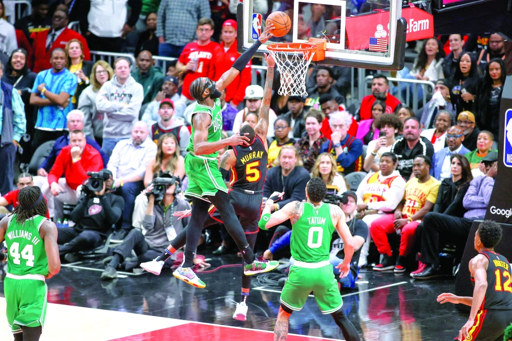 Boston Celtics guard Jaylen Brown (7) blocks the shot of Atlanta Hawks guard Dejounte Murray (5) in the second half during game six of the 2023 NBA play-offs at State Farm Arena. Mandatory Credit: Brett Davis-USA TODAY Sports