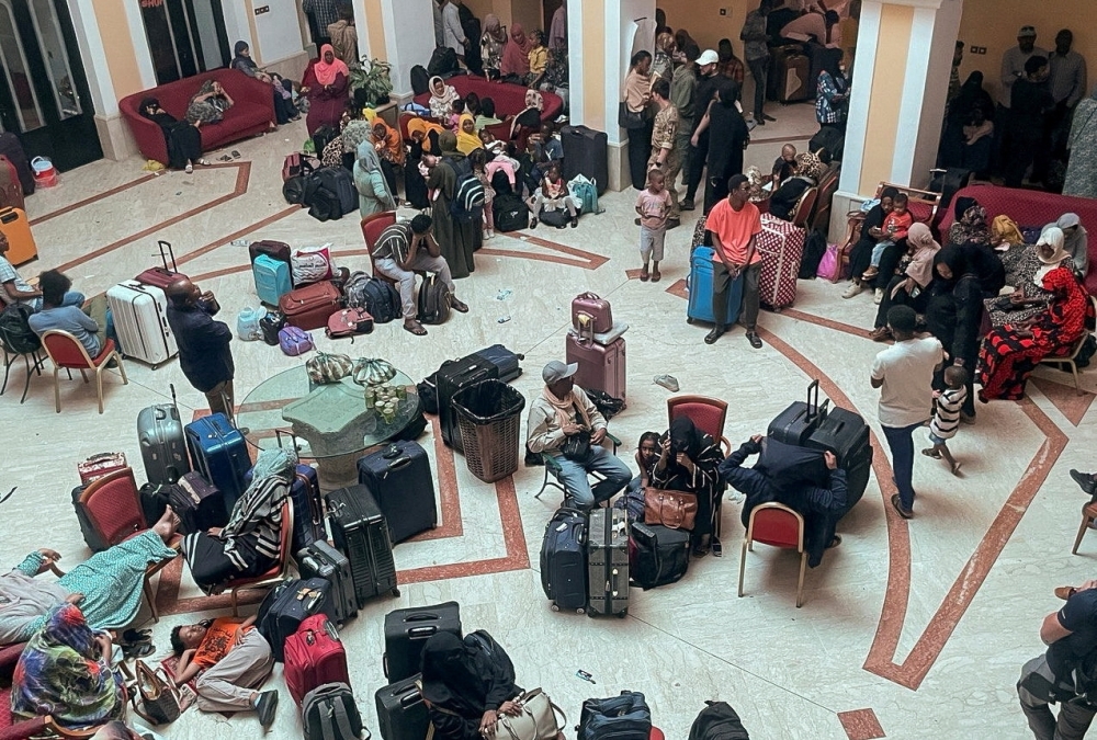 Sudanese citizens wait with their luggage at a makeshift center to be processed for evacuation, following the crisis in Sudan's capital Khartoum, in Port Sudan, Sudan, May 2, 2023. REUTERS/El Tayeb Siddig REFILE - CORRECTING LOCATION
