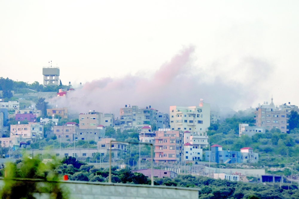 Smoke billows as Israeli forces demolish Palestinian homes in the village of Hares, in the occupied West Bank. — AFP
