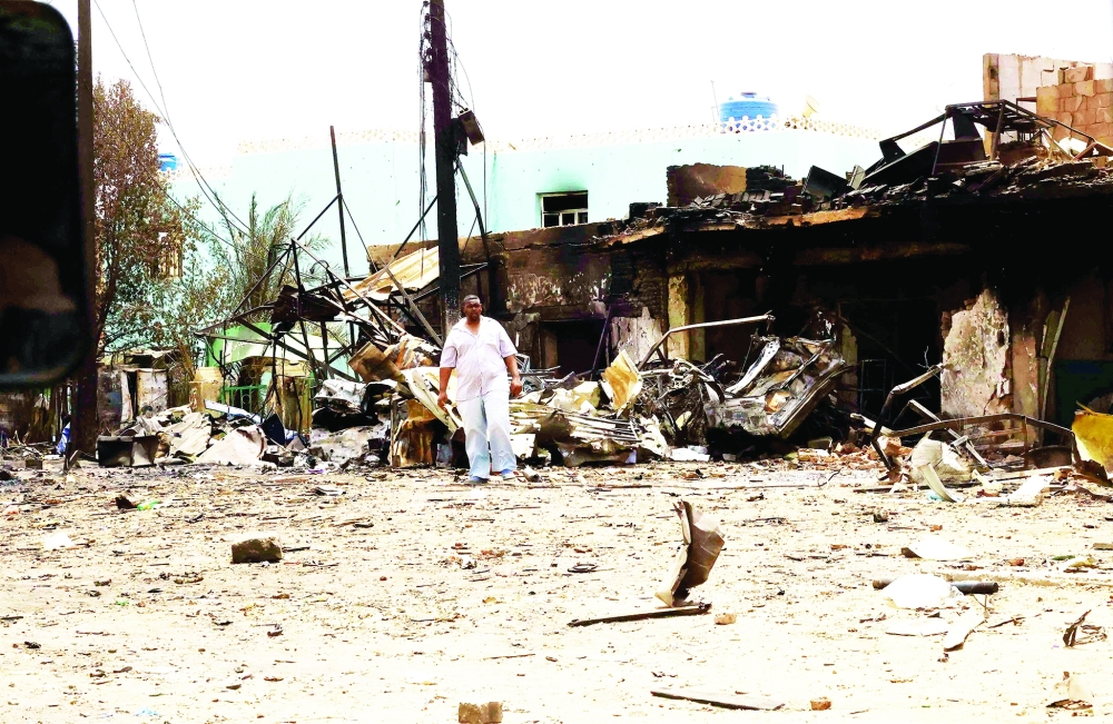  A man walks near damaged buildings at the central market during clashes between the paramilitary Rapid Support Forces and the army in Khartoum North, Sudan. REUTERS