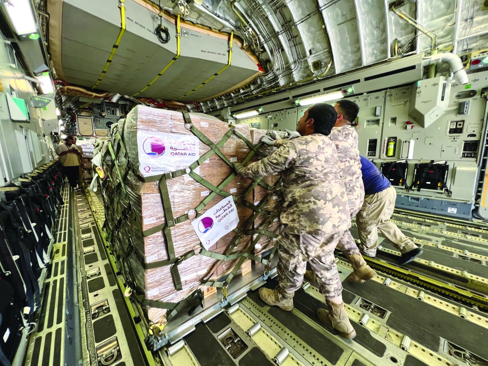 Officials of Qatar Emiri Air Force load aid to a Qatar Emiri Air Force cargo plane carring aid to Sudan, at Al Udeid Air Base, Doha, Qatar, May 5, 2023. — Reuters