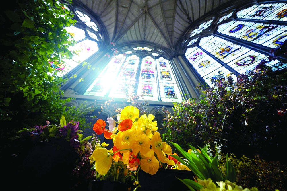 A picture shows some of the coronation service flowers, including a bunch of poppies, at Chapter House in Westminster Abbey in London ahead of the coronation of Britain's King Charles III. - AFP