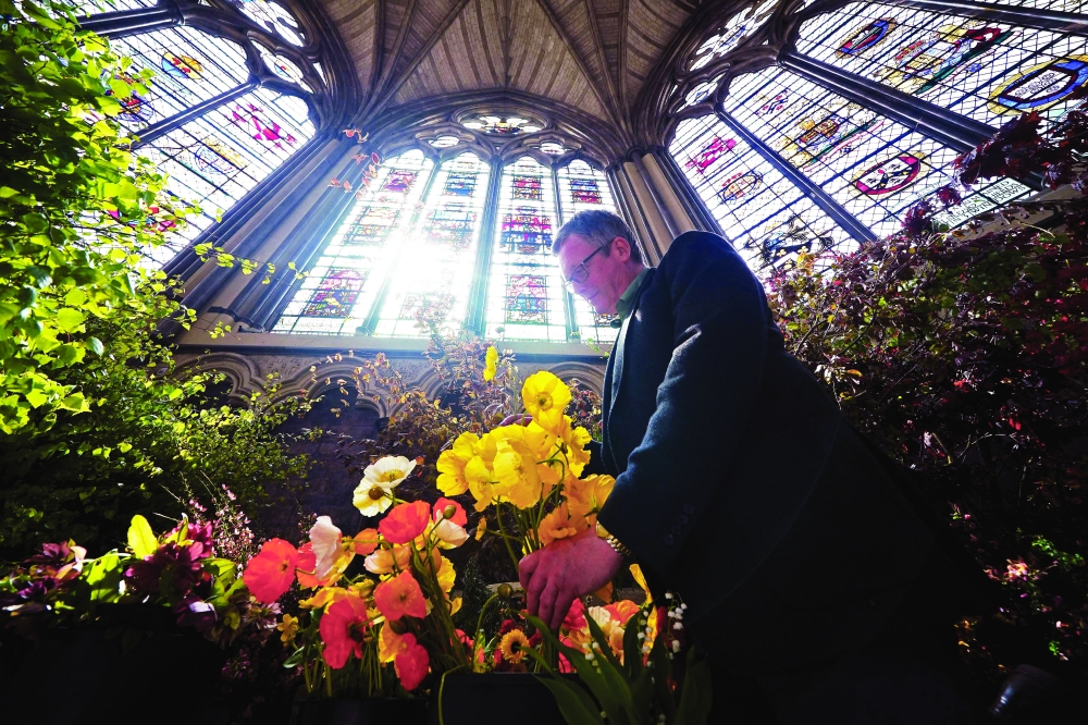 Florist Shane Connolly holds a bunch of poppies as he poses with coronation service flowers at Chapter House in Westminster Abbey in London ahead of the coronation of Britain’s King Charles III. — AFP