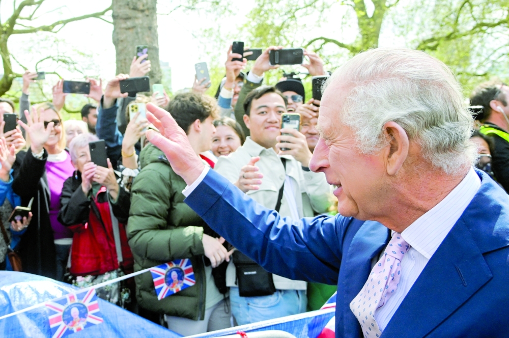 Britain's King Charles meets well-wishers during a walkabout on the Mall outside Buckingham Palace ahead of his and Camilla, Queen Consort's coronation, in London. - Reuters