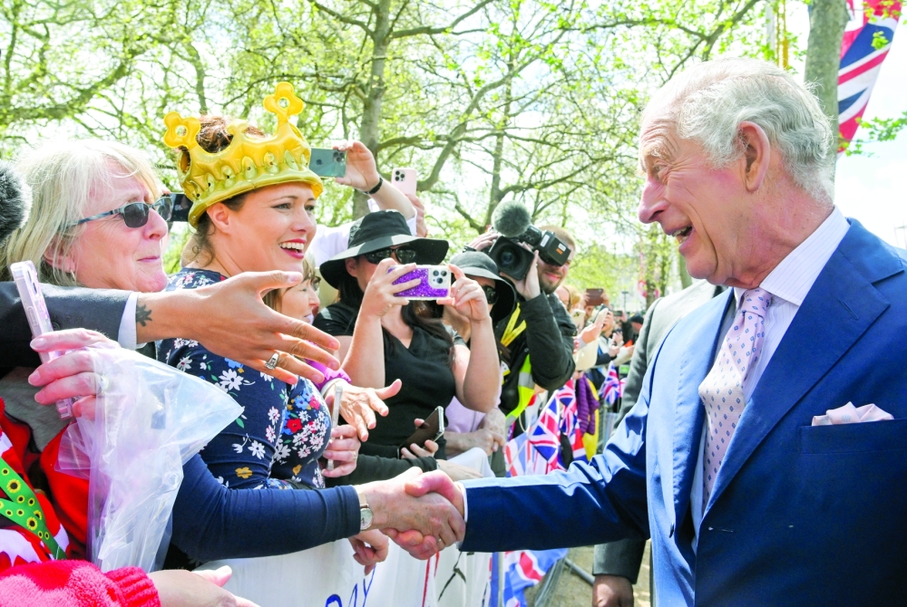 Britain's King Charles meets well-wishers during a walkabout on the Mall outside Buckingham Palace ahead of his and Camilla, Queen Consort's coronation, in London. - Reuters