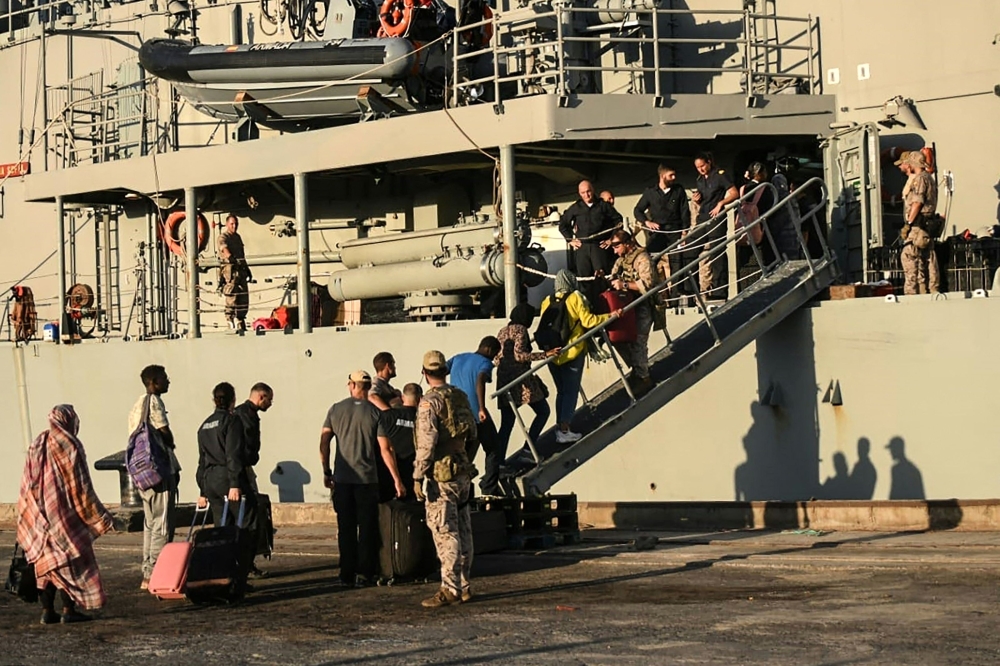 People from various nationalities board the Spanish frigate during an evacuation from Port Sudan toward Saudi Arabia