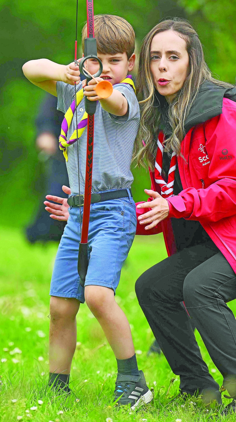 Britain’s Prince Louis of Wales tries his hand at archery while taking part in the Big Help Out, during a visit to the 3rd Upton Scouts Hut in Slough, west of London on Monday, where the family joined volunteers helping to renovate and improve the building. People across Britain were asked to do their duty as the celebrations for King Charles III’s coronation drew to a close with a massive volunteering drive. — AFP