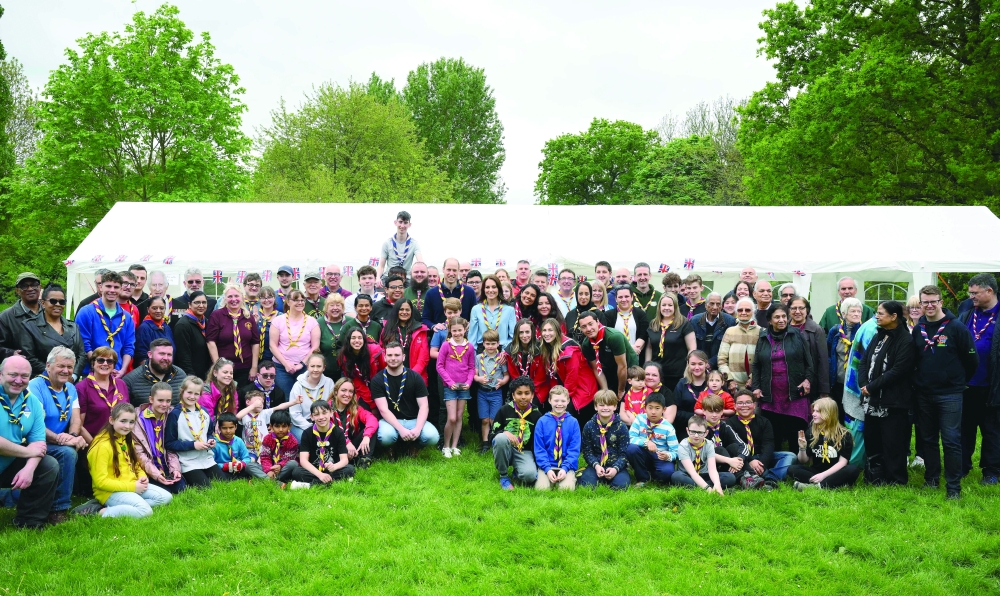 Standing in the middle, Britain's royals pose for a group pictures with volunteers to a close with a massive volunteering drive. — AFP