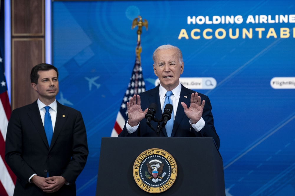 President Joe Biden delivers remarks about protecting consumers when there are significant flight disruptions, while Secretary of Transportation Pete Buttigieg looks on, at the White House in Washington on Monday, May 8, 2023. (Doug Mills/The New York Times)