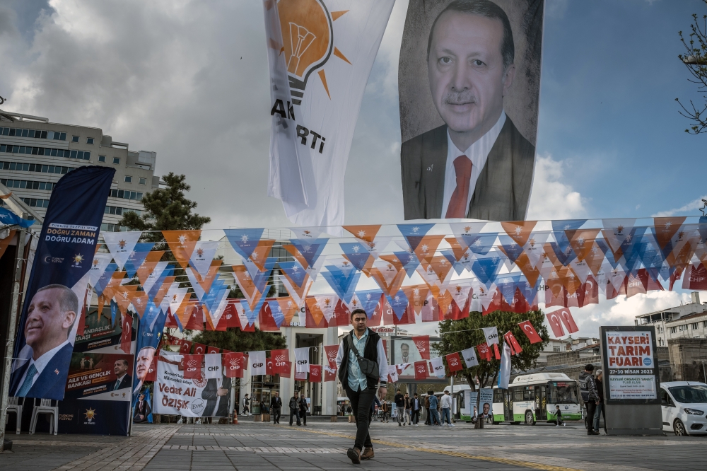 A banner depicting President Recep Tayyip Erdogan hangs amid flags for his Justice and Development Party and the opposition Republican Peoples Party in Kayseri, Turkey, on April 21, 2023. (Sergey Ponomarev/The New York Times)