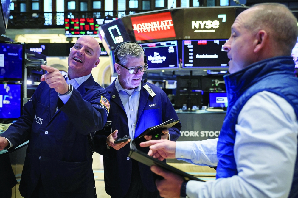 Traders work on the floor of the New York Stock Exchange in New York City. - Reuters 