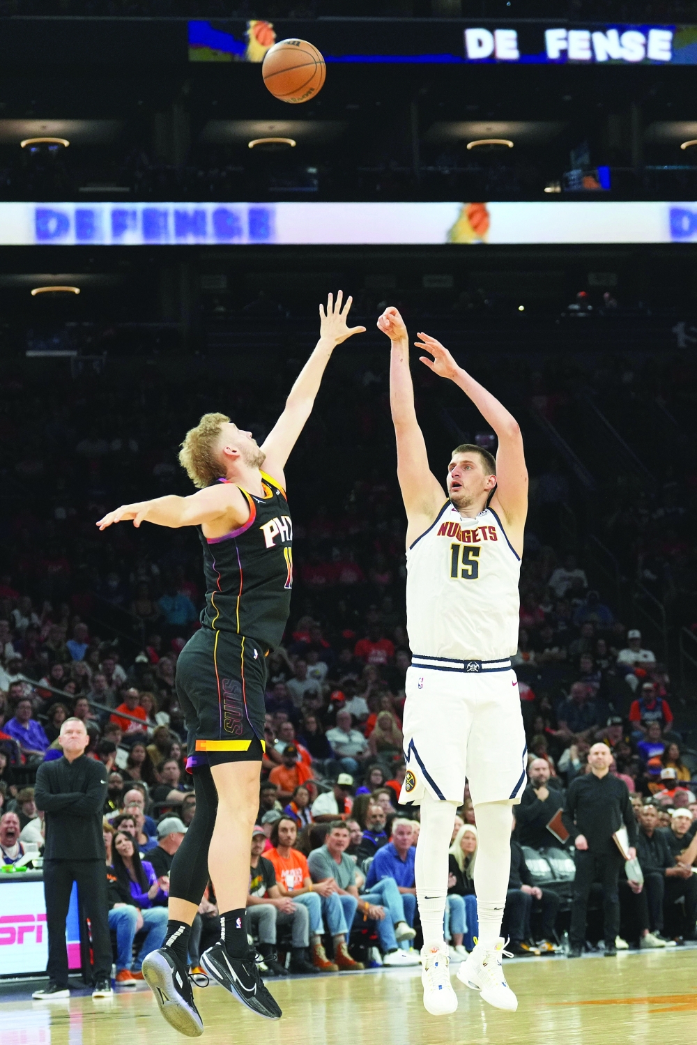 Denver Nuggets centre Nikola Jokic (15) shoots over Phoenix Suns centre Jock Landale (11) during the second half of game six of the 2023 NBA play-offs at Footprint Center. Mandatory Credit: Joe Camporeale-USA TODAY Sports