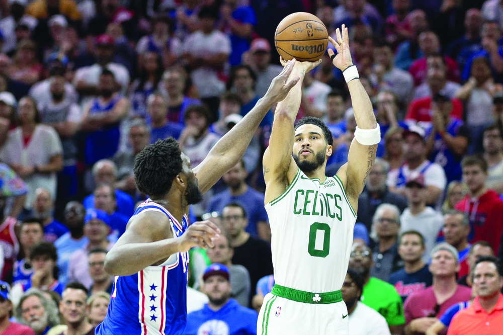 Boston Celtics forward Jayson Tatum (0) shoots the ball past Philadelphia 76ers centre Joel Embiid (21) during the fourth quarter in game six of the 2023 NBA play-offs at Wells Fargo Center. Mandatory Credit: Bill Streicher-USA TODAY Sports