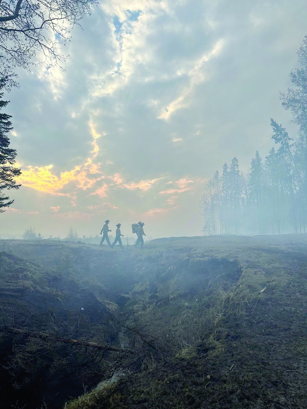 Firefighters return to retrieve more gear while tackling the Deep Creek Wildfire Complex near Entwistle, Alberta, Canada, on Monday. - Reuters
