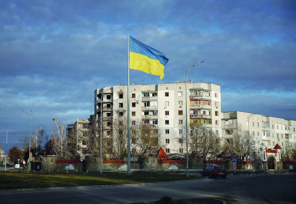 Ukrainian national flag flies near buildings destroyed by Russian military strike in Borodianka, in Kyiv region. — Reuters