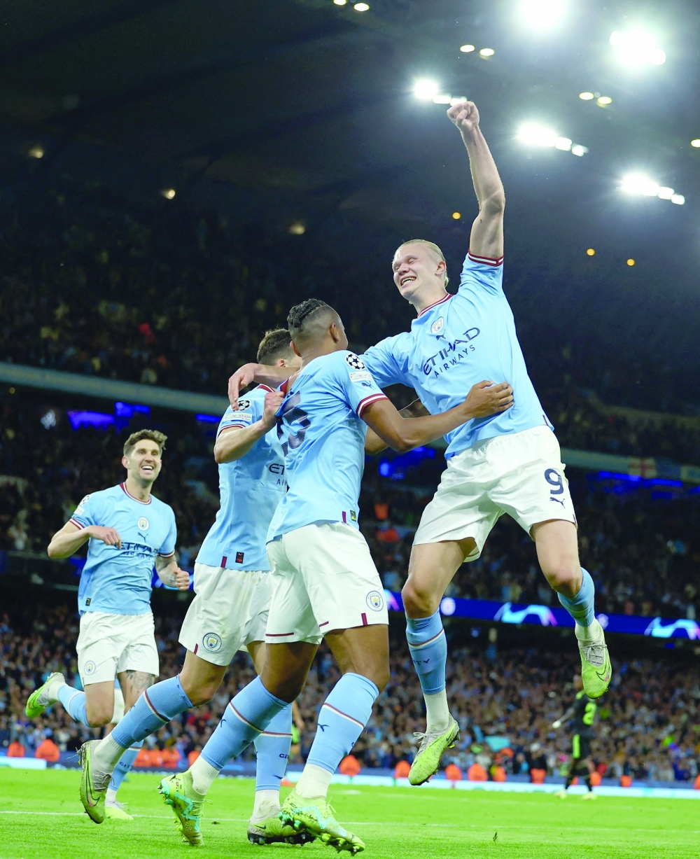 Soccer Football - Champions League - Semi Final - Second Leg - Manchester City v Real Madrid - Etihad Stadium, Manchester, Britain - May 17, 2023 Manchester City's John Stones, Erling Braut Haaland, Manuel Akanji and Ruben Dias celebrate their third goal an own goal scored by Real Madrid's Eder Militao REUTERS/Molly Darlington

