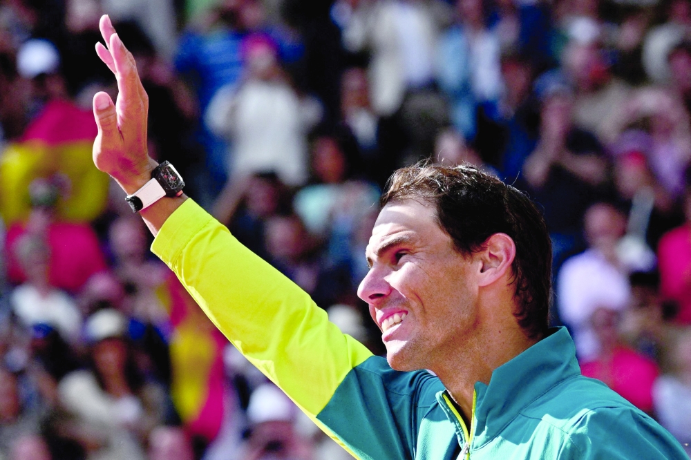 (FILES) Spain's Rafael Nadal waves as he celebrates after victory over Norway's Casper Ruud during their men's singles final match on day fifteen of the Roland-Garros Open tennis tournament at the Court Philippe-Chatrier in Paris on June 5, 2022. Rafael Nadal will announce if he will compete in the French Open on May 18, 2023, amid a long-term injury struggle and some Spanish reports that he will withdraw. The 22-time Grand Slam winner has battled to recover from a hip injury he sustained in January at the Australian Open, not playing since then. 
 (Photo by Anne-Christine POUJOULAT / AFP)

