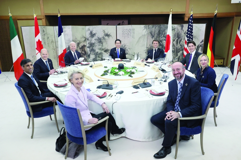 US President Joe Biden, Germany's Chancellor Olaf Scholz, Britain's Prime Minister Rishi Sunak, European Commission President Ursula von der Leyen, President of the European Council Charles Michel, Italy's Prime Minister Giorgia Meloni, Canada's Prime Minister Justin Trudeau, France's President Emmanuel Macron and Japan's Prime Minister Fumio Kishida attend a working dinner session during G7 leaders' summit in Hatsukaichi, Hiroshima prefecture, western Japan. - Reuters