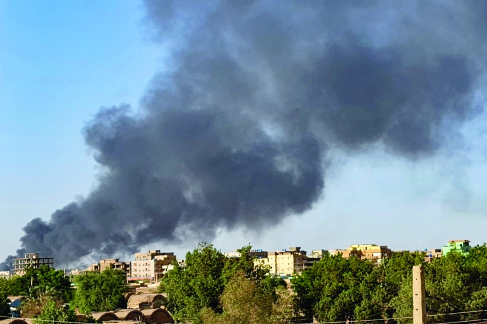 Smoke rises above buildings in Khartoum, as violence between two rival Sudanese generals continues, on May 17, 2023. Khartoum was again rocked by battles on May 17, more than a month into a brutal war that has made "more than half" of the already impoverished country in need of aid, according to the United Nations. AFP