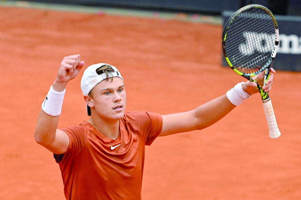 Denmark's Holger Rune celebrates after defeating Norway's Casper Ruud during their semifinals match of the Men's ATP Rome Open tennis tournament at Foro Italico in Rome on May 20, 2023.  (Photo by Tiziana FABI / AFP / )