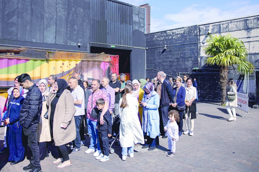 Turkish voters living in the Netherlands queue for early voting in the second round at a polling station in Amsterdam. — AFP