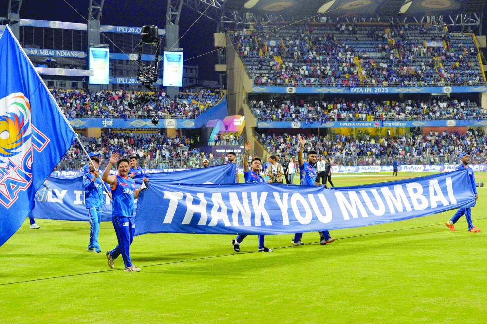 Mumbai Indians' players take a lap of honour at the end of the Indian Premier League (IPL) Twenty20 cricket match between Mumbai Indians and Sunrisers Hyderabad at the Wankhede Stadium in Mumbai on May 21, 2023. (Photo by Indranil MUKHERJEE                   / AFP / )

