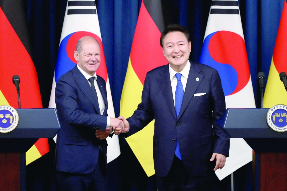Olaf Scholz shakes hands with Yoon Suk Yeol after their joint press conference at the Presidential Office in Seoul, South Korea. — Reuters