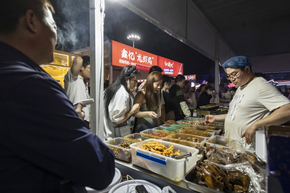 Diners pick out the food they want grill at a barbecue place in Zibo, China, May 2, 2023. (Qilai Shen/The New York Times)