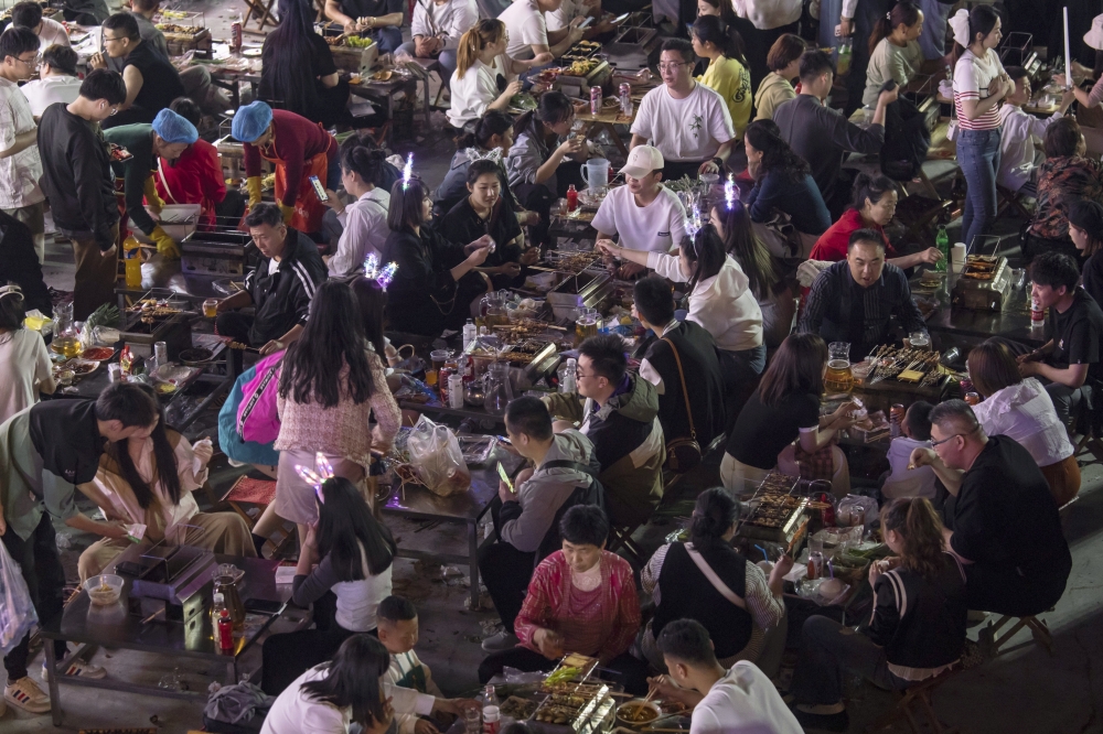 Crowds fill the tables for barbecue in Zibo, China, May 2, 2023. (Qilai Shen/The New York Times)