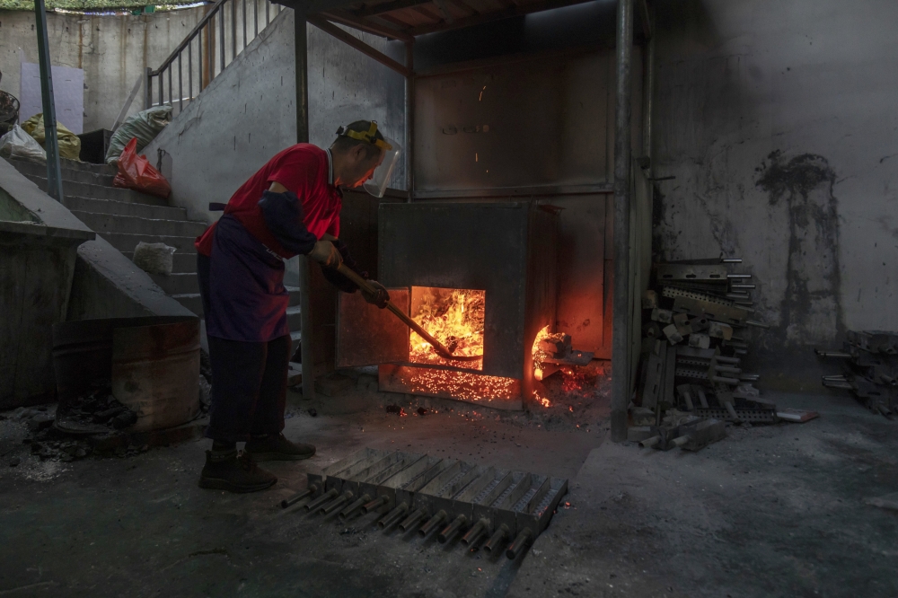 A charcoal maker for barbecue, in Zibo, China, May 2, 2023. (Qilai Shen/The New York Times)
